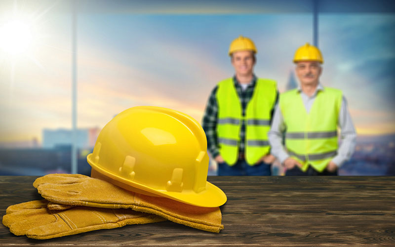 A Yellow Hard Hat Sitting on a Pair of Gloves A Yellow Hard Hat Sitting on a Pair of Gloves