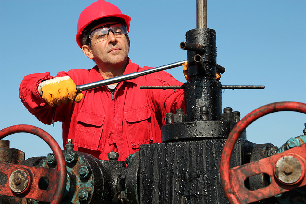 Man Working Wearing Hard Hat and Safety Glasses Man Working Wearing Hard Hat and Safety Glasses